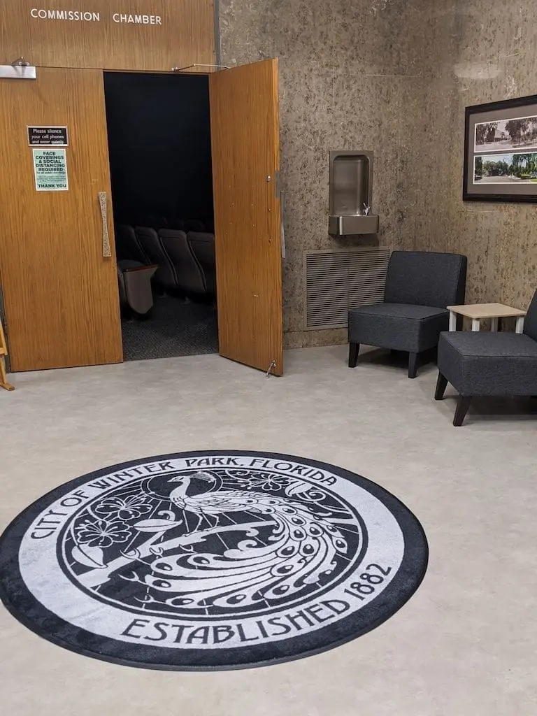 Custom branded real estate logo rug at Virginia office lobby entrance