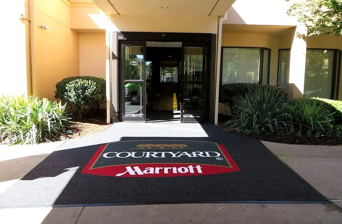 Personalized franchise logo mat with corporate branding applied to individual location