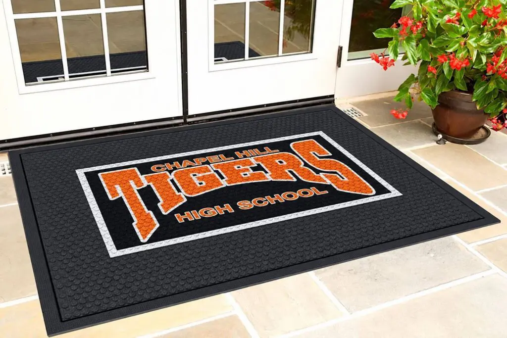 Chapel Hill Tigers High School custom SuperScrape Impressions rubber cleat entrance mat with orange logo installed at outdoor school entrance