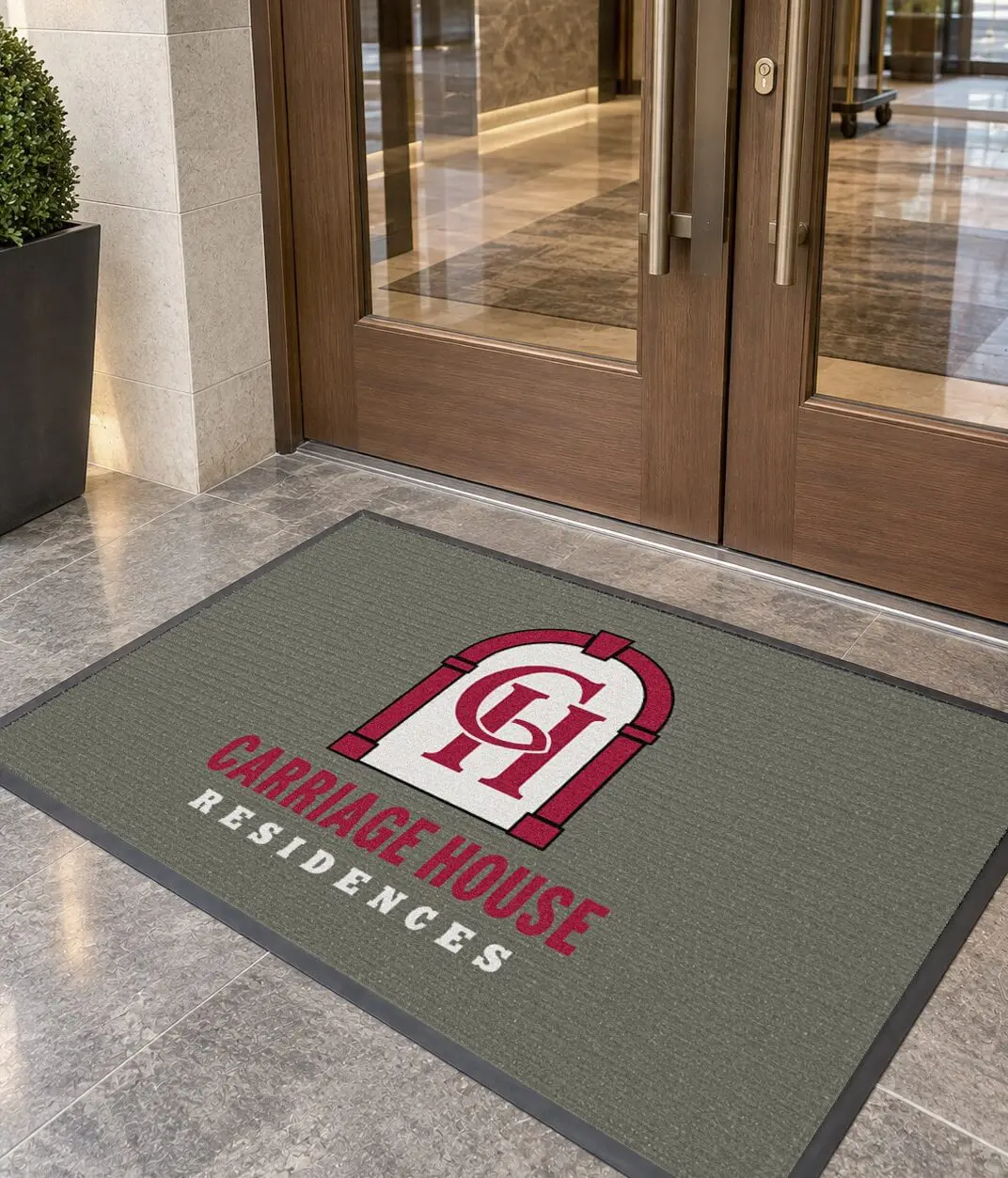 Design rendering of a Carriage House Residences custom logo entrance mat outside apartment building front doors