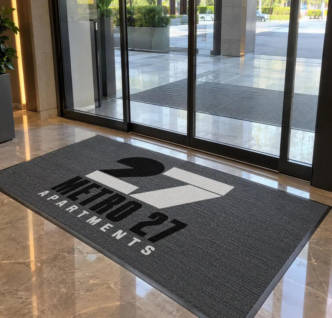 Design rendering of a Metro 27 Apartments indoor custom logo mat inside a building lobby entrance