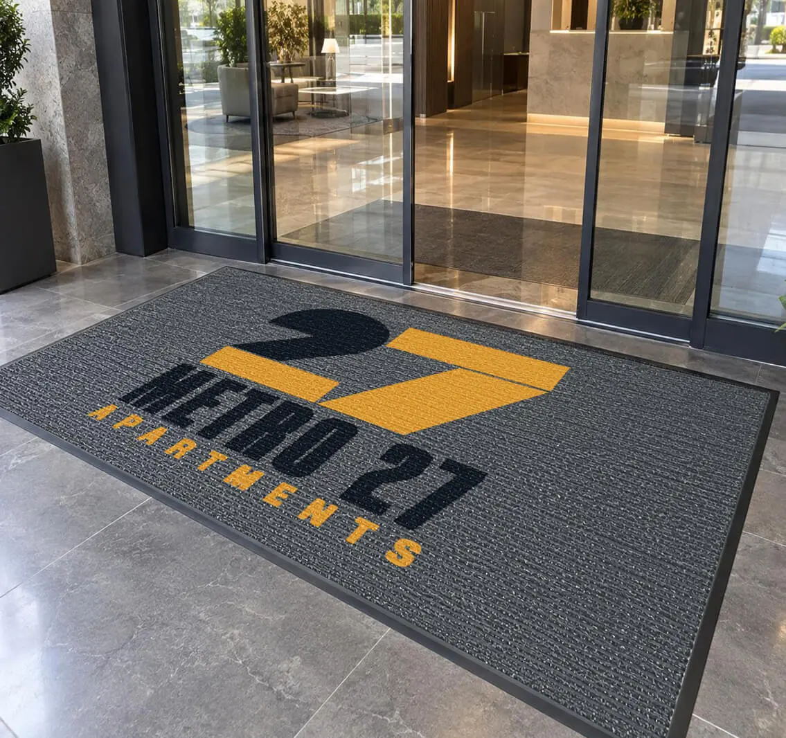 Design rendering of a Metro 27 Apartments outdoor custom logo mat outside building entrance doors