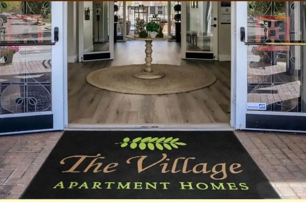 Design rendering of a The Village Apartment Homes custom logo entrance mat at property entrance by Rug Rats