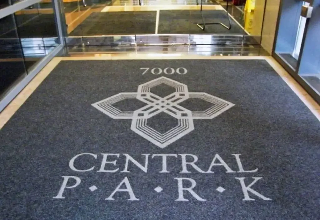 Finished custom Rug Rats logo mat installed at a Virginia commercial entrance — free 24-hour digital proof, no setup fee
