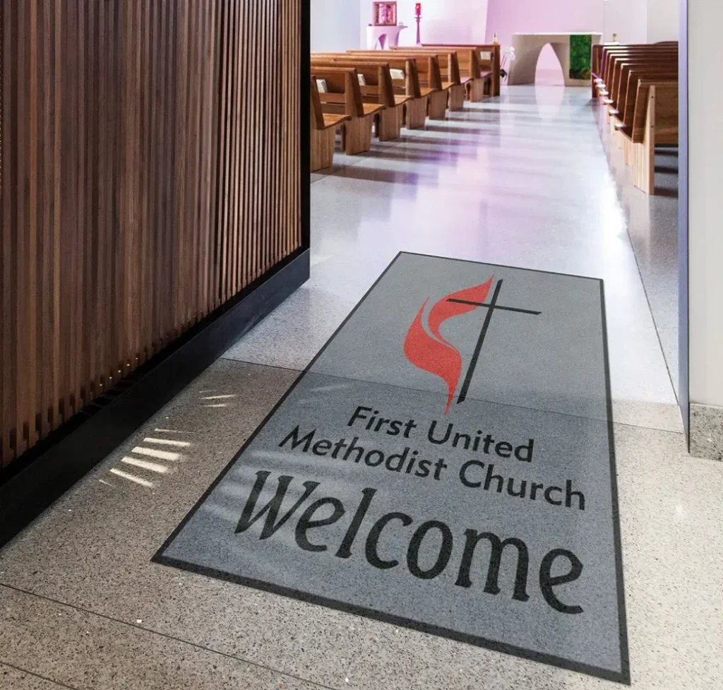 Piazza hand-inlaid custom logo mat by Rug Rats installed at an upscale corporate or church sanctuary entrance